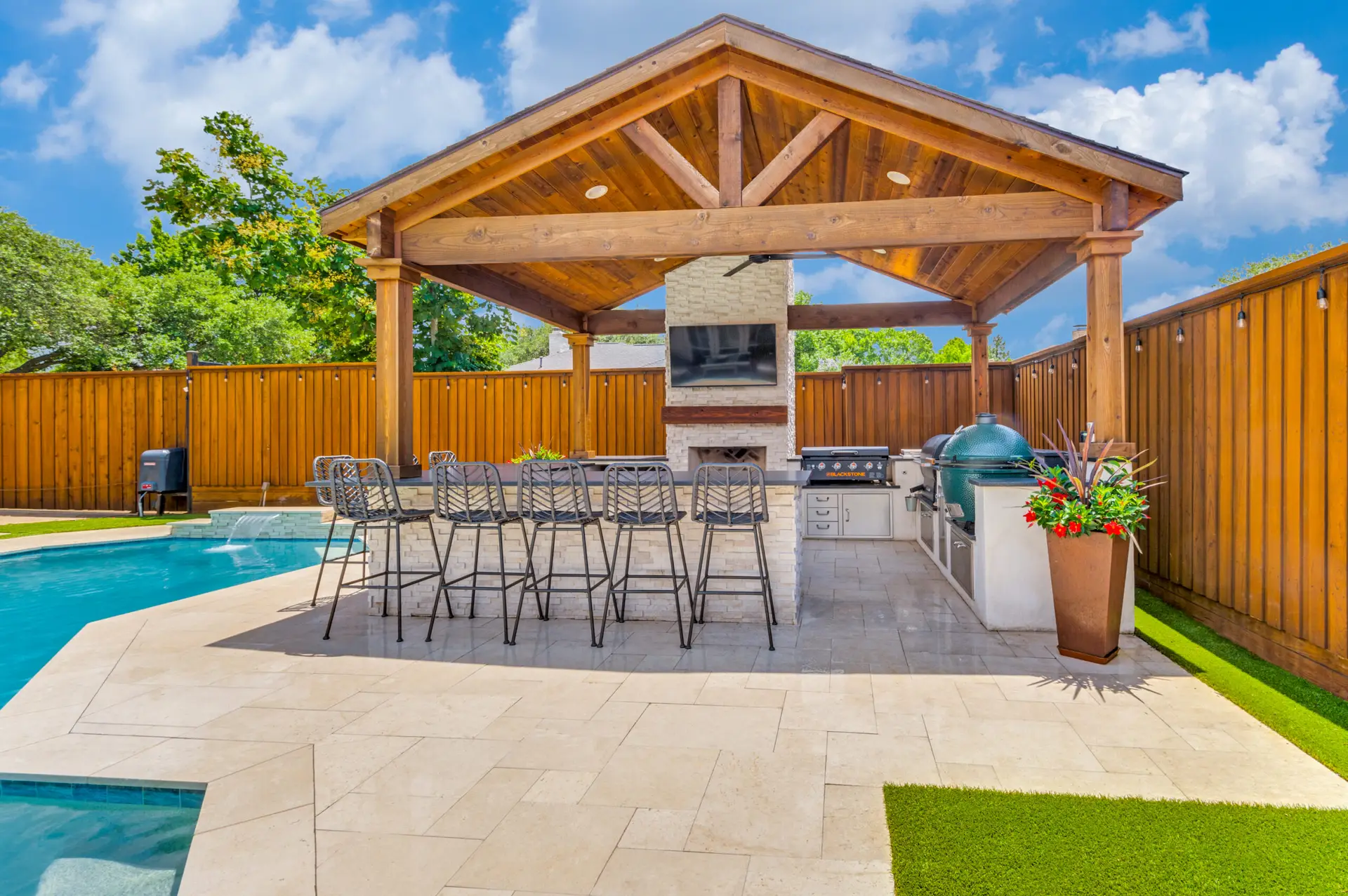 Outdoor kitchen beside of pool